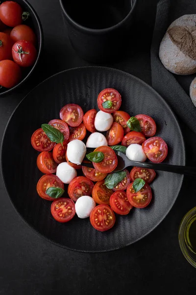 Cherry tomato salad with mozzarella cheese and fresh basil. Delicious caprese salad