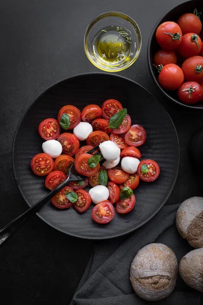 Cherry tomato salad with mozzarella cheese and fresh basil. Delicious caprese salad