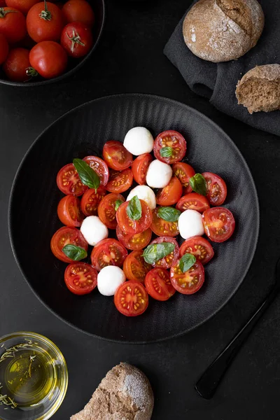 Cherry tomato salad with mozzarella cheese and fresh basil. Delicious caprese salad