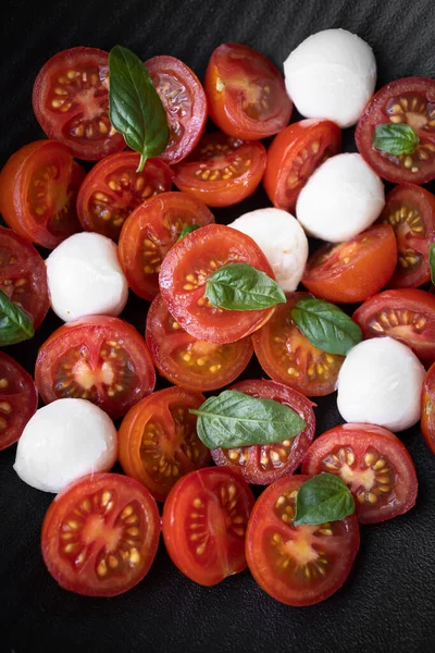 Cherry tomato salad with mozzarella cheese and fresh basil. Delicious caprese salad