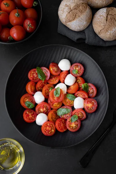 Cherry tomato salad with mozzarella cheese and fresh basil. Delicious caprese salad