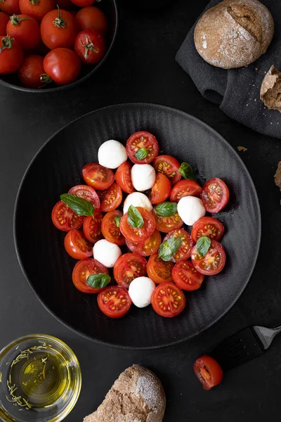 Cherry tomato salad with mozzarella cheese and fresh basil. Delicious caprese salad