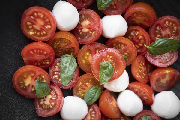 Cherry tomato salad with mozzarella cheese and fresh basil. Delicious caprese salad