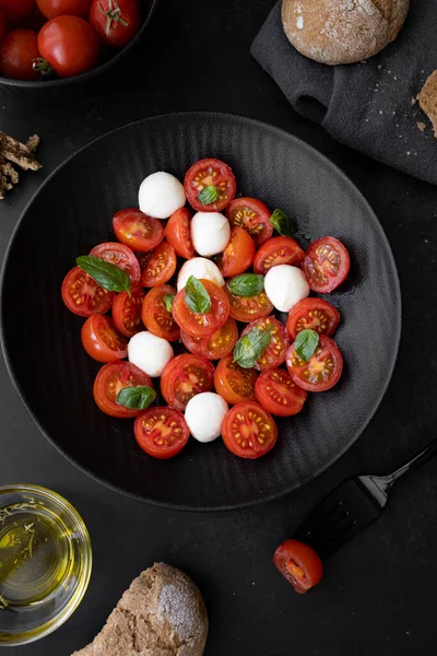 Cherry tomato salad with mozzarella cheese and fresh basil. Delicious caprese salad