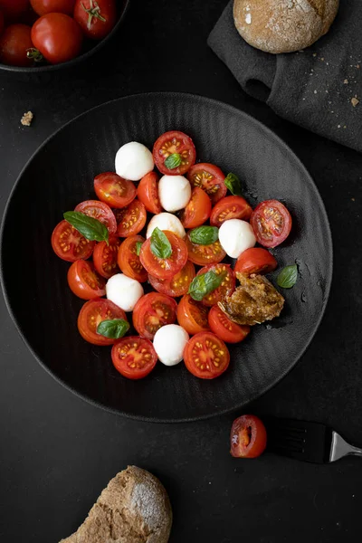 Cherry tomato salad with mozzarella cheese and fresh basil. Delicious caprese salad