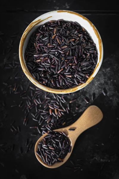 Black rice, also known as purple rice or forbidden rice. Organic unpolished black rice grains as a source of complex carbohydrates and high in antioxidants.