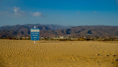 Playa del Ingles, Maspaloma, Gran Canaria, İspanya 'daki Maspalomas Kumulları manzarası. Güneşte rahatlayabilen çıplaklara adanmış bir alan, yıl boyunca 23 derece sabit sıcaklık..