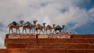 20 12 2020 Silver camels in Petra Jordan handmade by Bedouins to be sold in Petra to tourists set on red stone with sky background