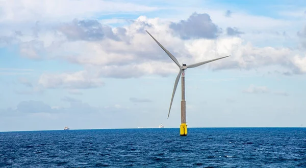 February 03 2022.A giant eolian wind turbine producing green energy in the Atlantic Ocean near the western coast of Gran Canaria.In the background are blue sky.