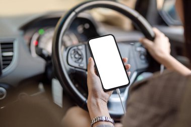 Arabada genç bir kadının elinin telefon numarasına yakın durun. Model.