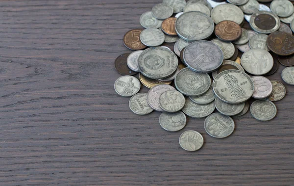 old coins, commemorative coins of the USSR, against the background of an old board