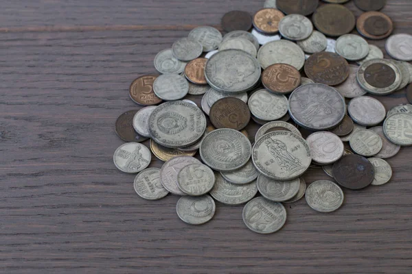 old coins, commemorative coins of the USSR, against the background of an old board