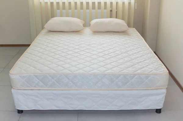 double bed frame with soft mattress cover and pillows