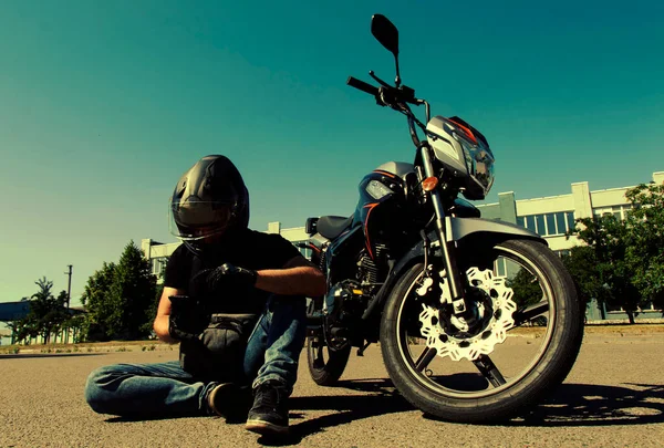 Motorcyclist Helmet Sits Road Next Motorcycle Looks Phone — Photo