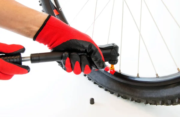 inflate a flat tire of a bicycle with a hand pump, close-up, on an isolated white background