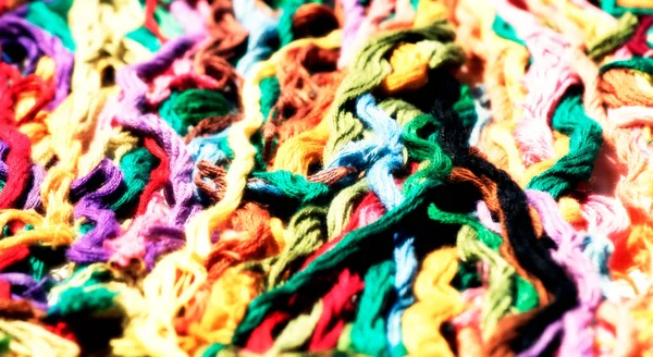 multi-colored threads for embroidery, floss, Mixed colorful texture of interlaced threads