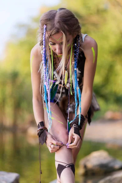 Girl Blue Pigtails Dressed Amazon Bending Tie Her Shoes Backdrop — Zdjęcie stockowe
