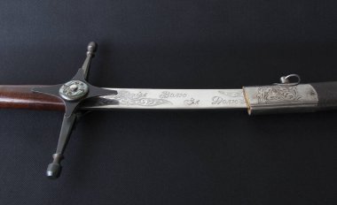 Ukrainian Cossack saber in a scabbard, with the inscription (For freedom, for destiny) close-up on a black background