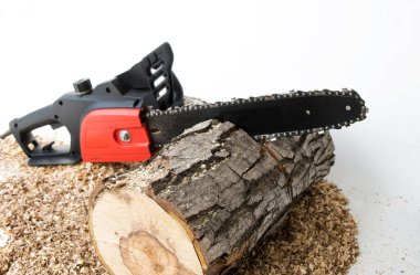 Hand chain electric saw, sawn log, on a white isolated background