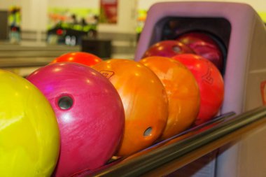 multi-colored bowling balls in a bowl