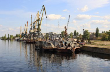 river cargo port with cranes, view from the river