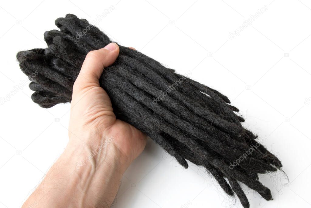 dreadlocks in hand, woven artificial kanekalon, for weaving into a hairstyle, close-up on a white isolated background