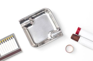 cigar in cigar case and open box of matches near ashtray, on isolated white background