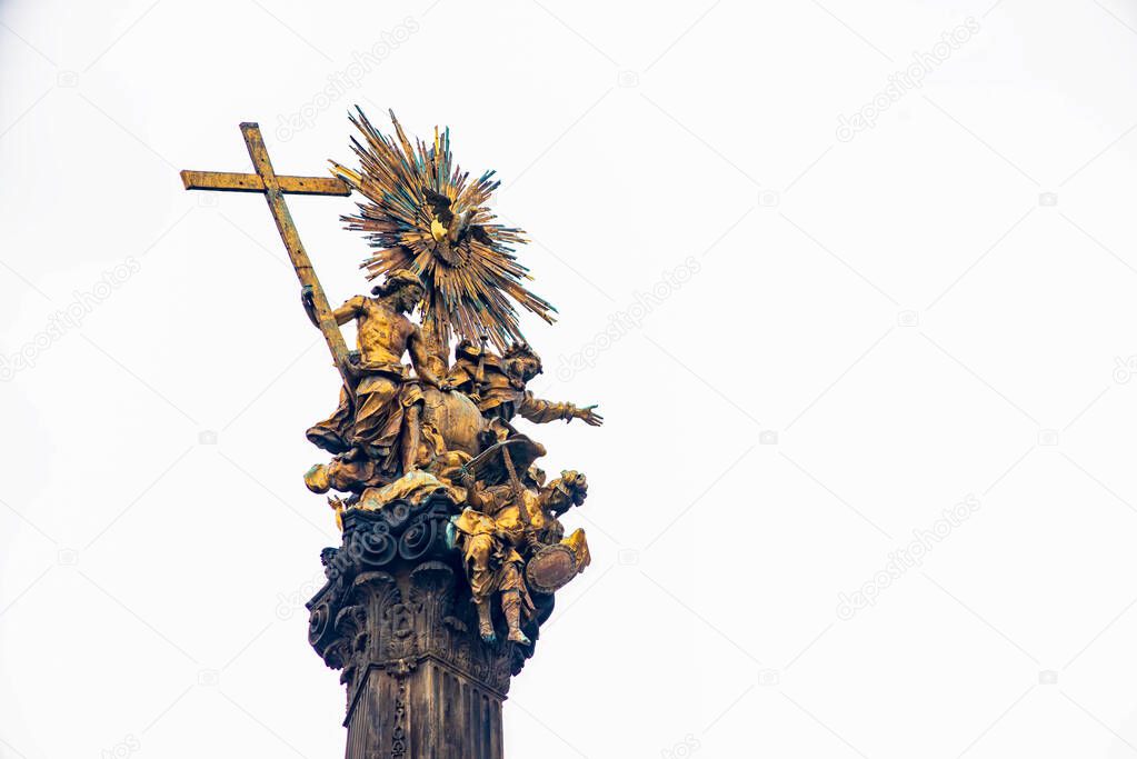 Gilded statue of the Holy Trinity atop the Plague column in Olomouc, Czech Republic. UNESCO World Heritage Site. Isolated on white