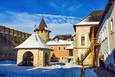 Inner yard of medieval Khotyn fortress at sunny winter day. Castle well, Commandant's tower and Prince's palace. Chernivtsi region. Ukraine. Khotyn fortress is s popular travel destination in Ukraine