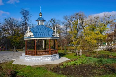 Okhtyrka, Sumy Bölgesi, Ukrayna 'daki halk parkında oyulmuş ahşap romantik çardak manzarası