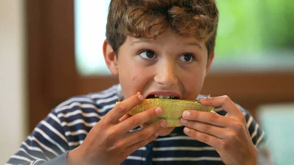 Young Boy Eating Melon Fruit Child Eats Healthy Food — Fotografia de Stock