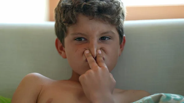 Child grimacing, kid funny face grimace close-up boy face