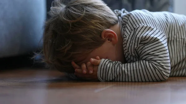 Child crying on floor having tantrum little boy cries