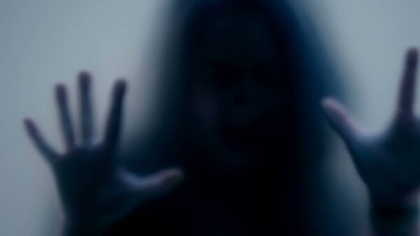 Defocused shot of person trapped in emotional problems behind glass depression concept