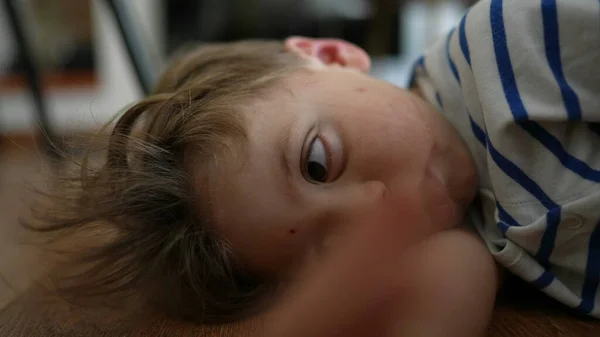 Расстроенный Скучный Ребенок Закатывает Глаза Чувствуя Скуку Лежа Полу Дома — стоковое фото