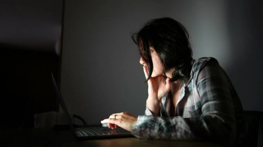 Gece bilgisayar ekranına bakan kişi internette geziniyor