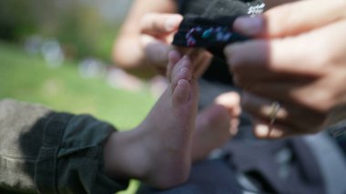 Ebeveynler çocuk ayaklarına çorap giydiriyor