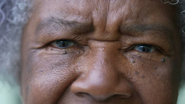 A senior woman macro closeup face eyes looking at camera