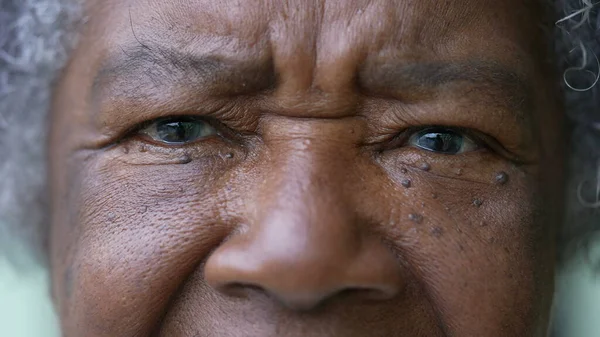 A senior woman macro closeup face eyes looking at camera