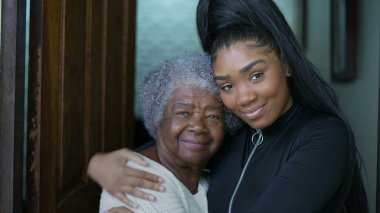 Grand daughter embracing senior grandmother authentic family love and embrace