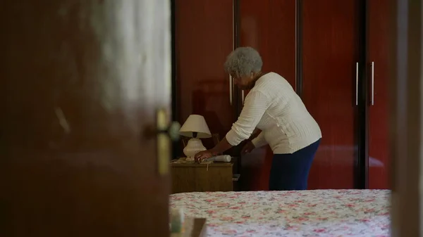 One Senior Black Woman Organizing Home Bedroom — ストック写真
