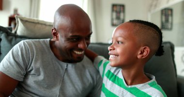 Father and child relationship. African parents and little boy interaction mixed race ethnicity