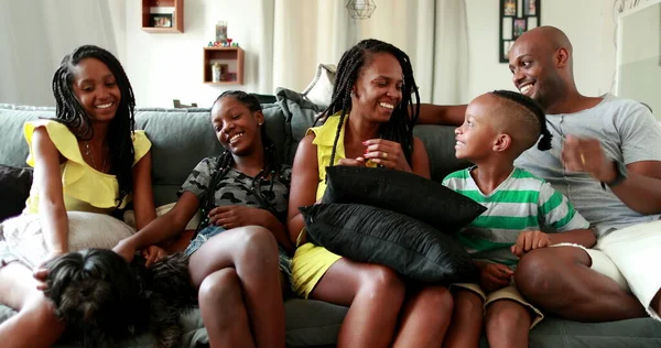 African family together at home couch. Black ethnicity parents and children living-room sofa, love and affection