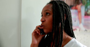Mixed race girl speaking on smartphone device. Teenager answering call