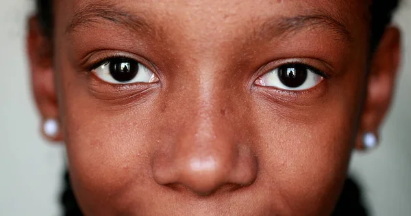 Black African girl eyes smiling at camera, Macro close-up