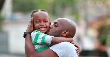 Father and son love and affection. Black African ethnicity. Dad and kid embrace