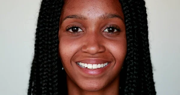 Young black woman smiling at camera, Portrait African American girl portrait face close-up smile