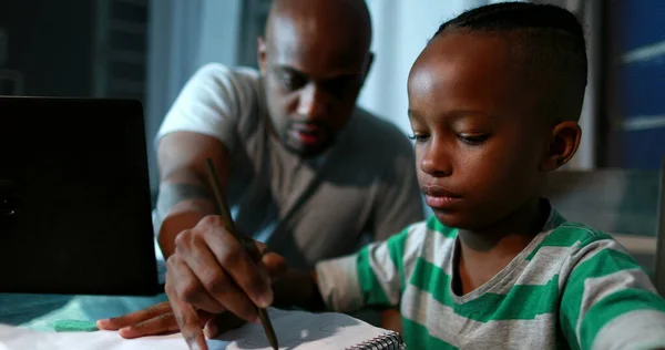 Father mentoring son, dad helping kid with homework study