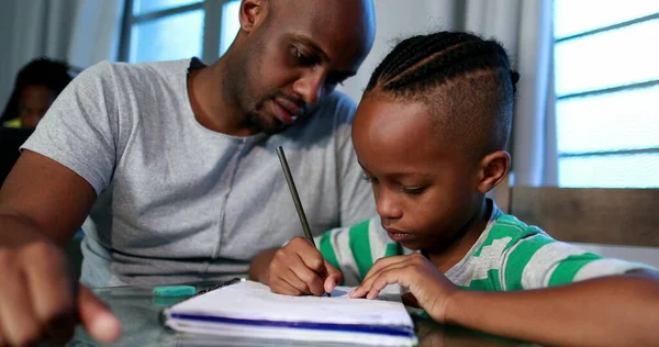 Father mentoring son, dad helping kid with homework study