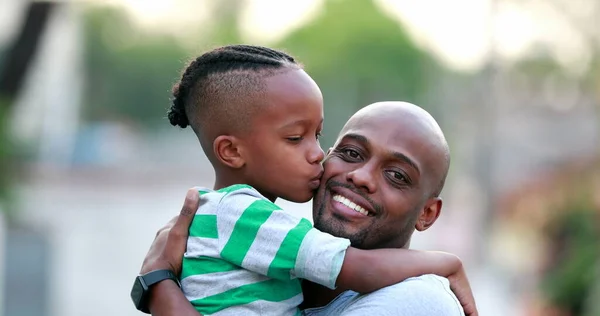 Father and son love and affection. Black African ethnicity. Dad and kid embrace